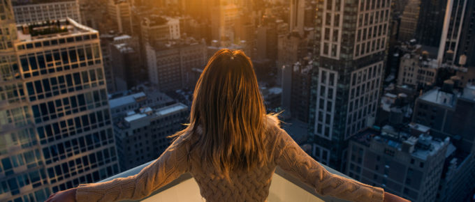 rich woman on balcony watching the sunset