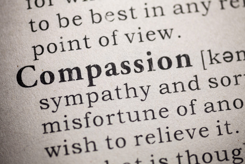 The word "compassion" in a dictionary with definition.