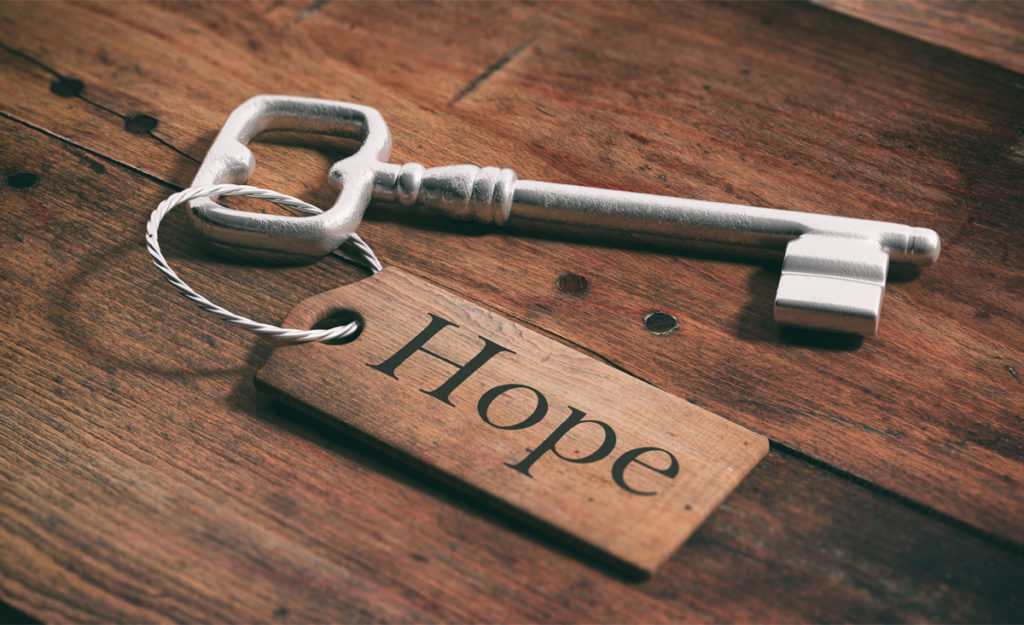The word "hope" attached to an old key.