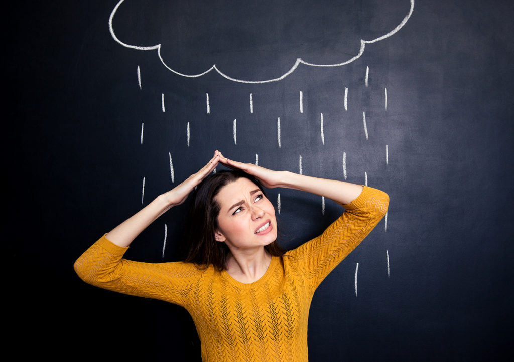 Unlucky woman being rained on