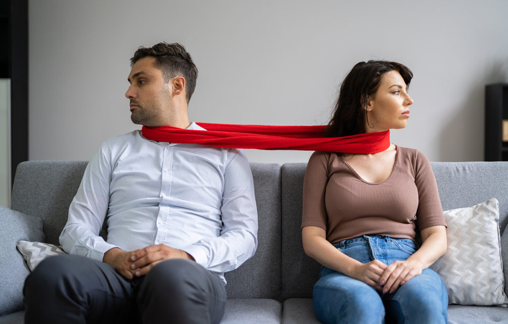 codependent couple on sofa