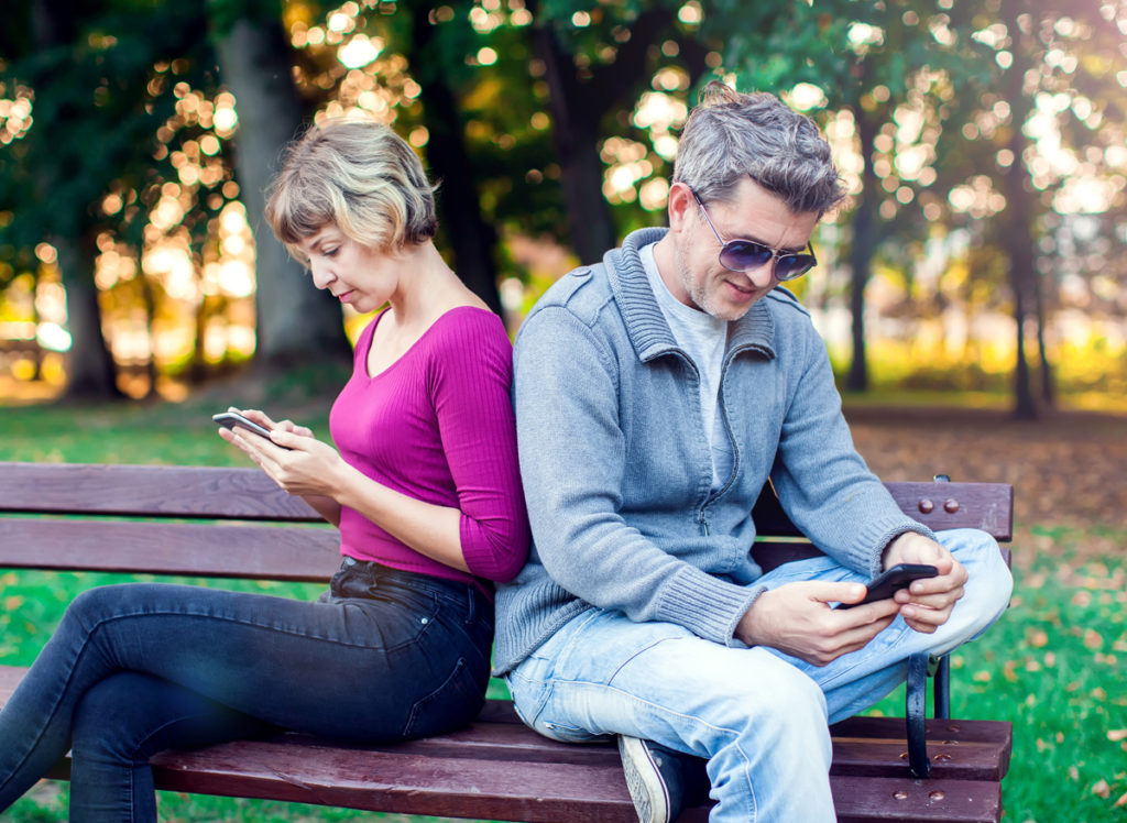 unhappy couple on park bench. 